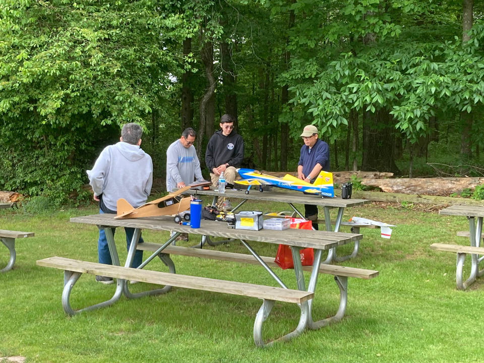 Club members gather around a plane