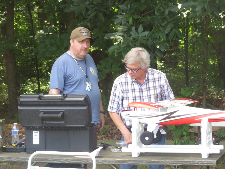 Club members work on a plane
